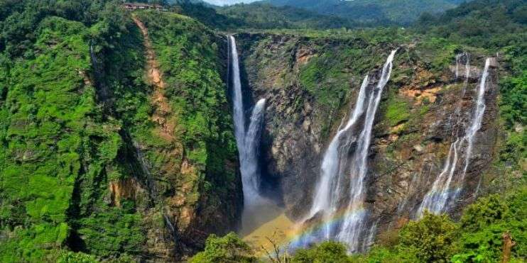 a Manikyadhara waterfall with a rainbow in Chikamagalur