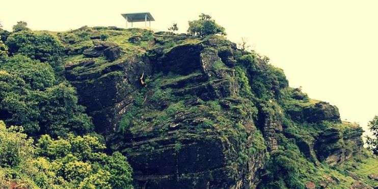 a structure on a cliff in Manikyadhara falls 