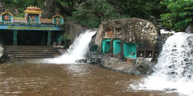 Veerabhadreshwara Temple at Kalhatti Falls, dedicated to Lord Shiva, showcases Vijayanagara architecture amidst a scenic waterfall.