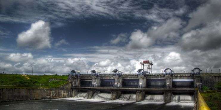 Aerial view of a massive dam with cascading water, showcasing the power and beauty of nature's force.