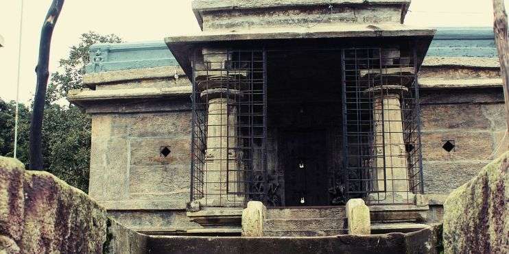 The entrance to a stone building with a gate, showcasing architectural beauty and a sense of grandeur.