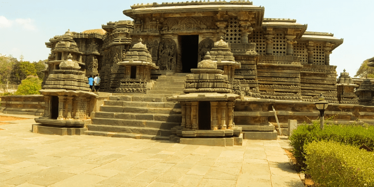 Ancient temple with intricate stone carvings and steps leading up to the entrance.