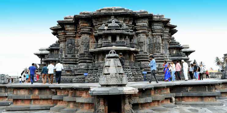 Tourists gather around a massive stone structure, captivated by its grandeur and historical significance.