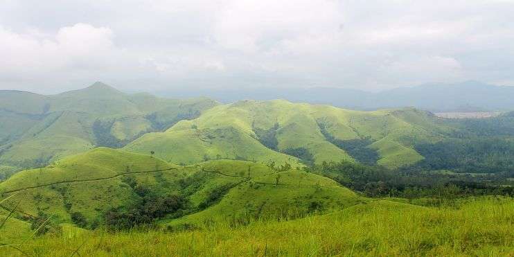 A scenic view of mountains from a hilltop, showcasing the beauty of nature's grandeur.