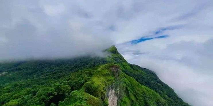 Aerial view of mountains with clouds in the sky.