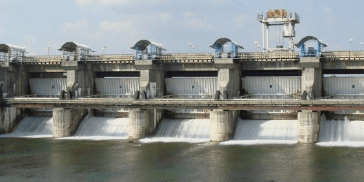 Aerial view of a massive dam with cascading water, showcasing the power and beauty of nature's force.