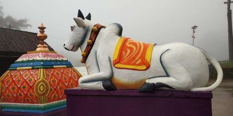 Sacred cow sculpture atop Bhairaveshwara Temple, representing divine presence.