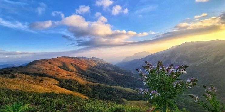 The sun sets behind the mountains in a breathtaking landscape