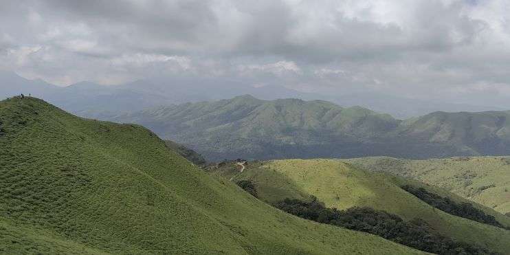 Aerial view of majestic mountains from a hilltop, showcasing the beauty of nature's grandeur.