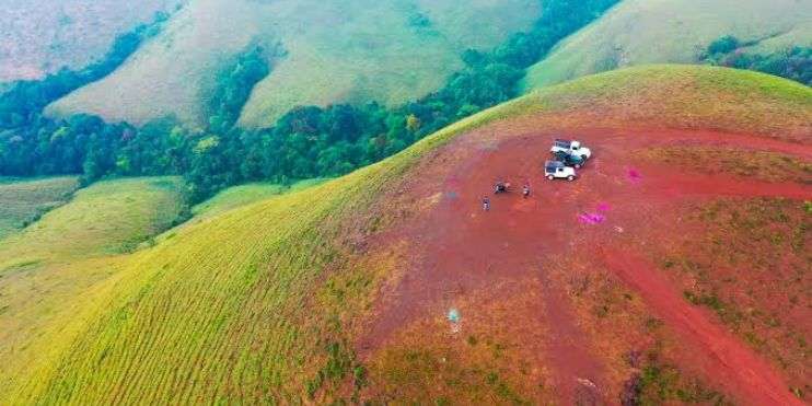 A truck driving on a hill, seen from above.