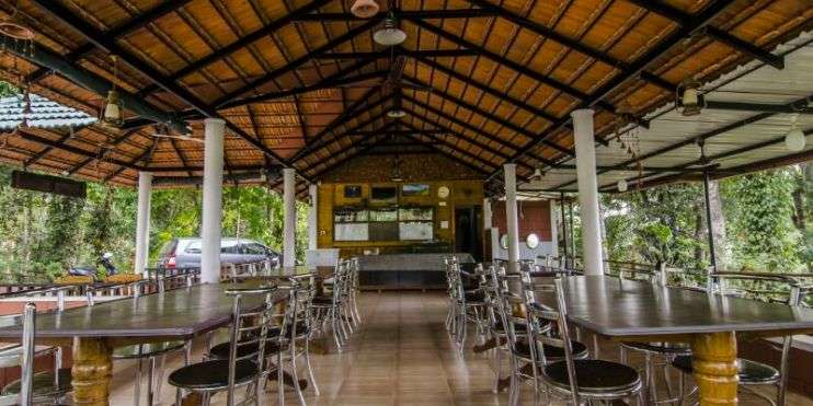 Al fresco dining setup at a restaurant specializing in local cuisine, under a covered roof.