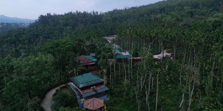 Bird's eye perspective of house in wooded surroundings at Bynekaadu Resort.