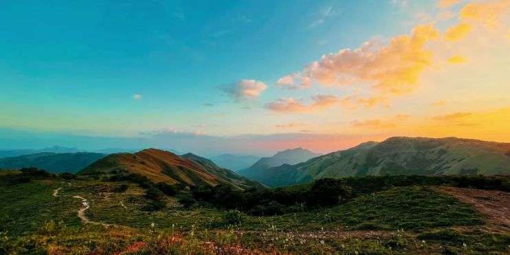 Majestic sunset over mountains, creating a stunning silhouette.