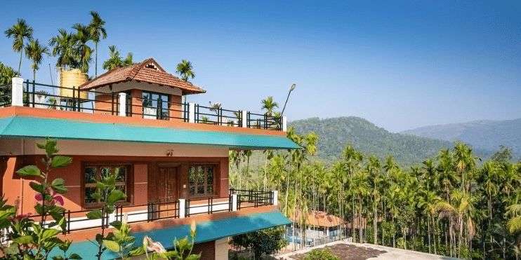 A lovely house with a balcony, providing a scenic view of the mountains, nestled in the peaceful Western Ghats of Chikmagalur. 