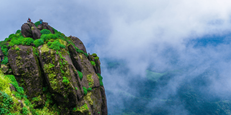 Adventurers gather at the summit of Kurinjal Peak, reflecting on their rewarding trekking experience in the Kalasa region.