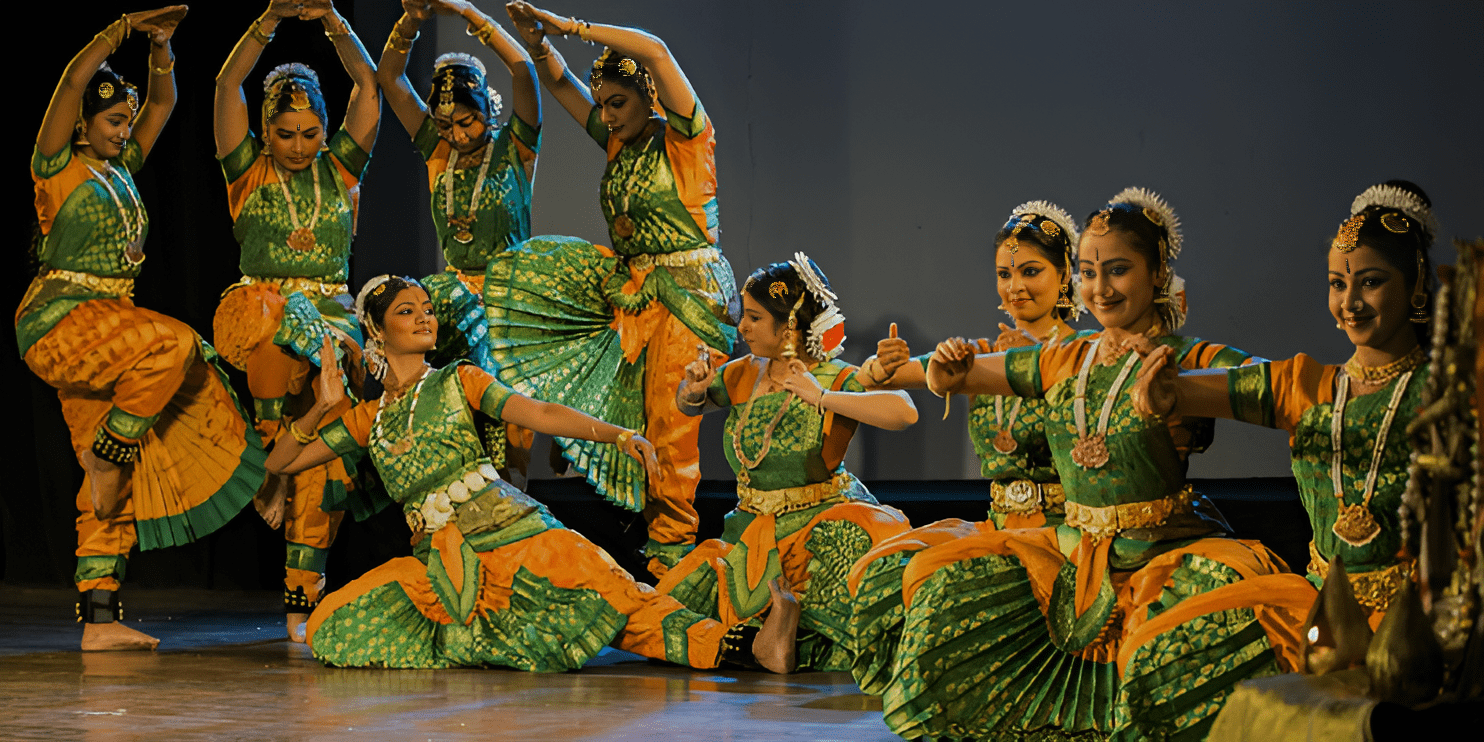  A vibrant group of women in colorful outfits performing traditional dance at the Pattadakal Dance Festival in January.