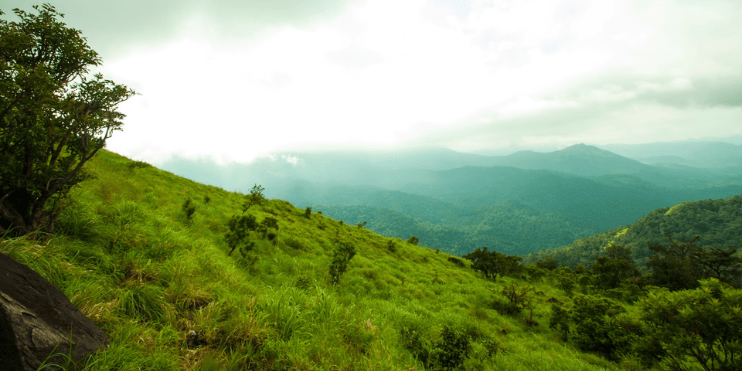 A breathtaking view of the Western Ghats from Bale Kallu Gudda, ideal for photography at sunrise or sunset.