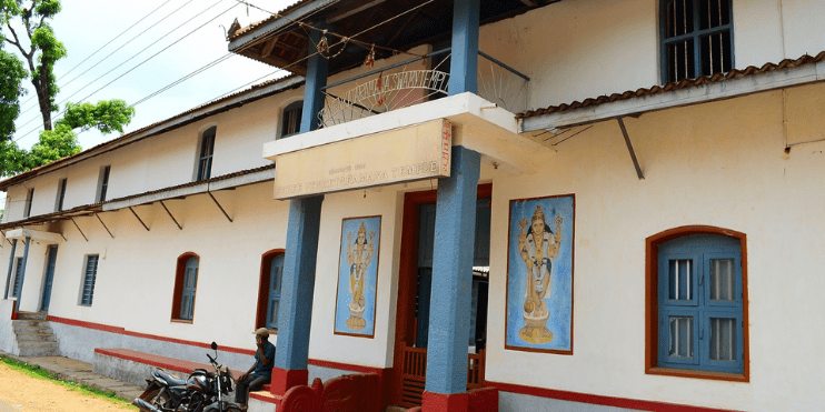 A building with a motorcycle parked outside, symbolizing a journey of spiritual peace and energy from the temple visit.