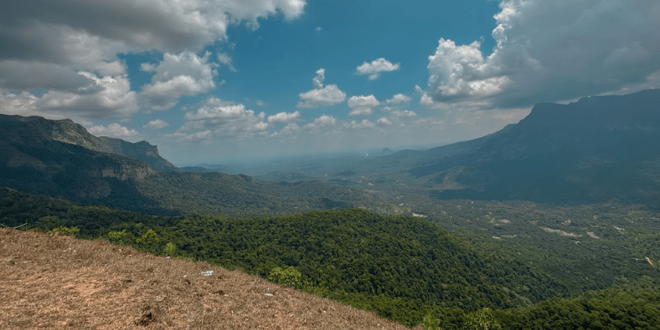 Scenic view from Maidaadi Sunset Viewpoint atop a mountain in Sri Lanka, showcasing the stunning Western Ghats landscape.