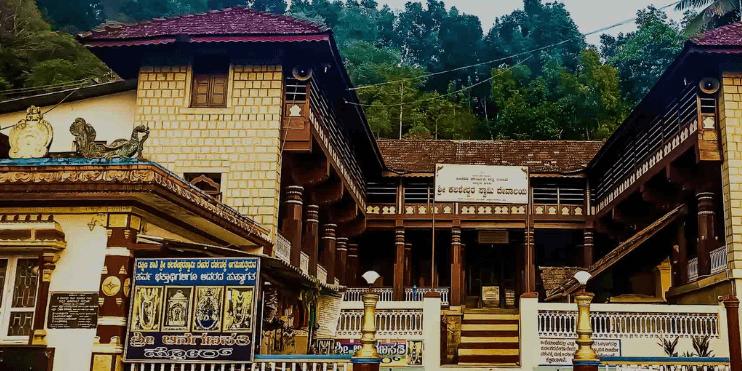 A multi-windowed building with balconies nestled in the serene mountains, reflecting spiritual and natural beauty.