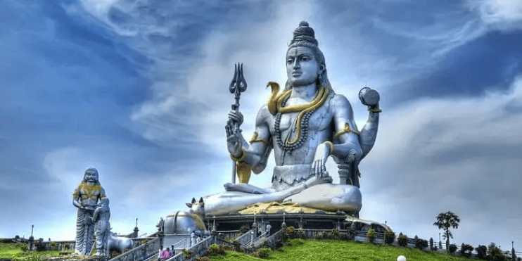 A majestic statue of Lord Shiva atop a hill, overlooking the Arabian Sea at Murudeshwara Temple in Karnataka.