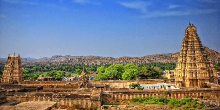 Ancient city of Hampi, India, featuring the Virupaksha Temple, a UNESCO site known for its intricate carvings and high gopuram.