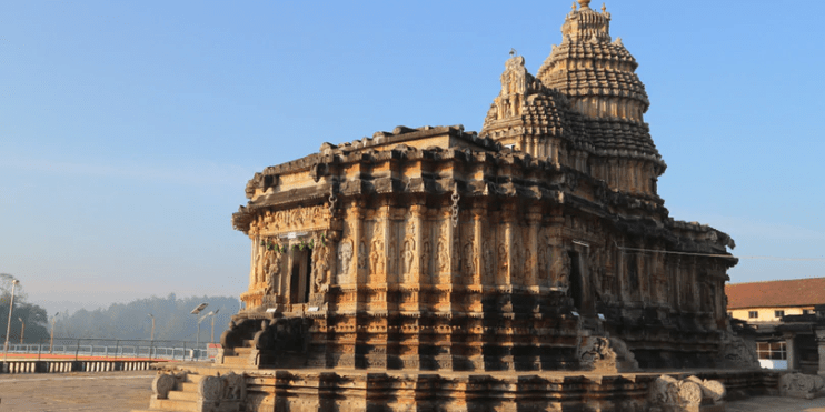 A majestic temple featuring a large tower, showcasing intricate Dravidian architecture and a serene atmosphere for reflection.