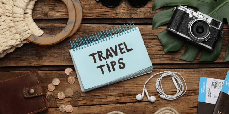 Travel tips displayed on a wooden table, highlighting essentials for a safe and enjoyable trek to Bettada Byraveshwara Temple.