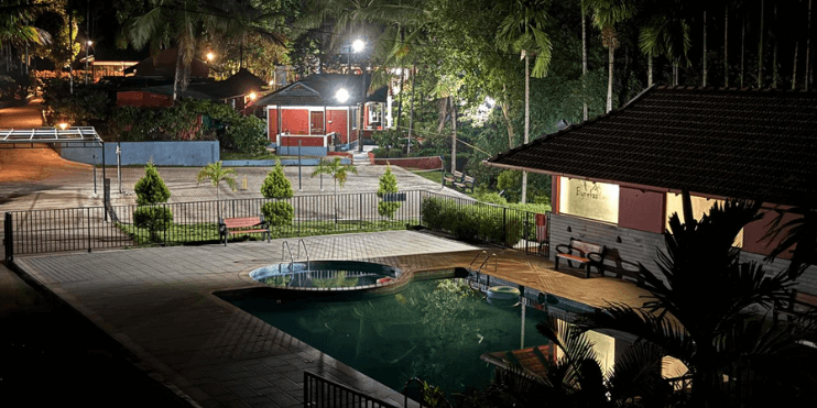 A serene night view of a pool illuminated by lights, creating a tranquil atmosphere for relaxation and enjoyment.