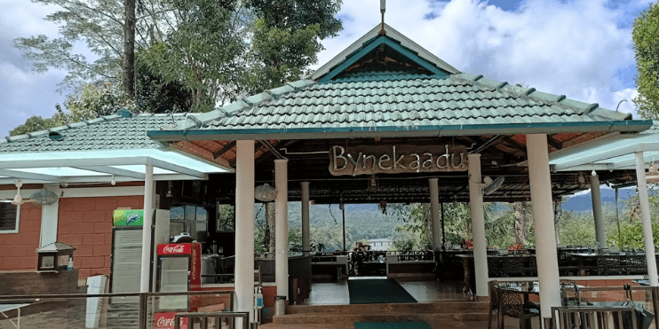 A restaurant featuring a roof and green tiled walls, providing a cozy atmosphere for guests to enjoy their meals.