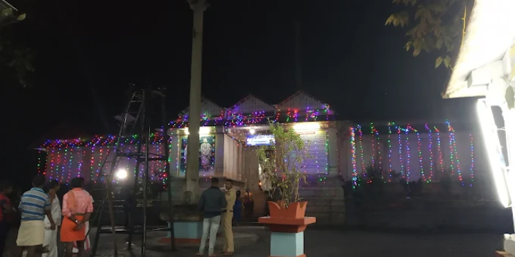 A brightly lit temple adorned with colorful lights, symbolizing celebration and community during a vibrant festival.