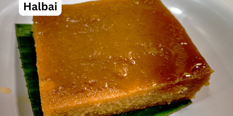 A square piece of Halbai cake on a plate, showcasing its soft, jelly-like texture and traditional sweet appearance.